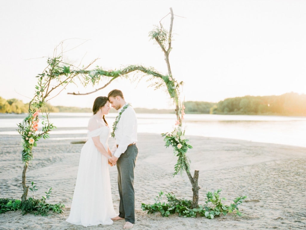 adventure elopement on a river with a floral arch made from driftwood | Nebraska elopement photographer