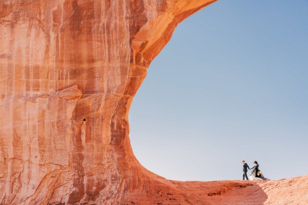 Adventure elopement in Moab, Utah in Arches National Park in a black wedding dress.