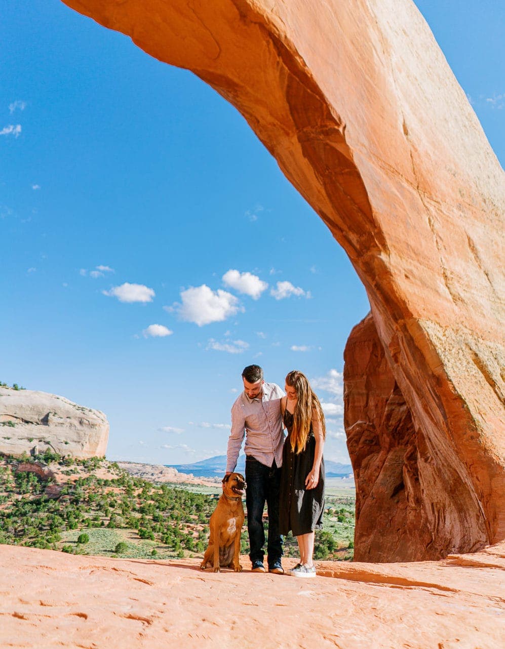 couple and their dog in Moab during an engagement session