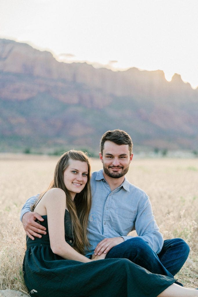 engagement session in Moab with Hidden Valley in the background