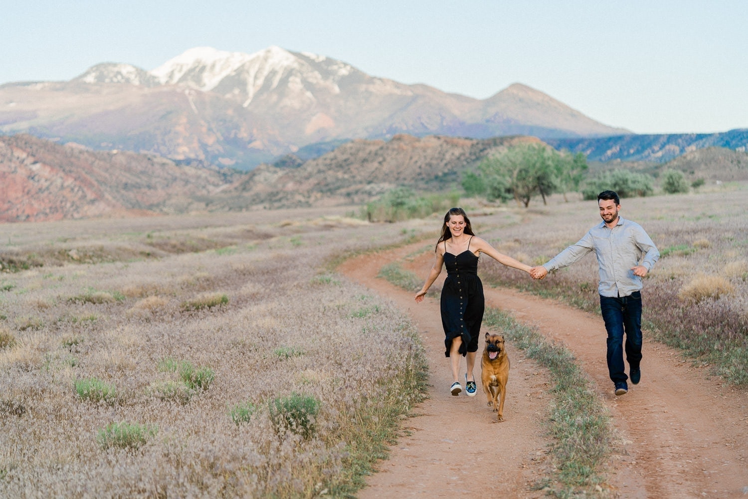 fun engagement session in Moab with a dog in the mountains