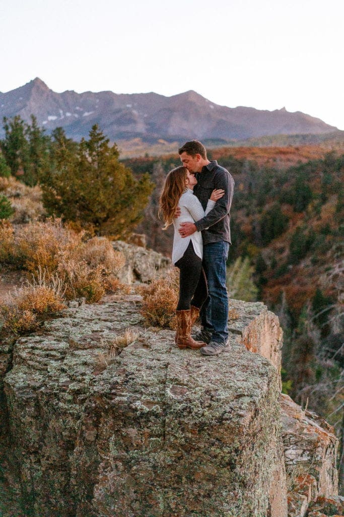 couple posing on the edge of the cliff in Ouray, Colorado