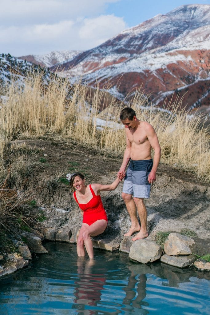 Bride and groom get into a hot springs after their winter elopement in Colorado.