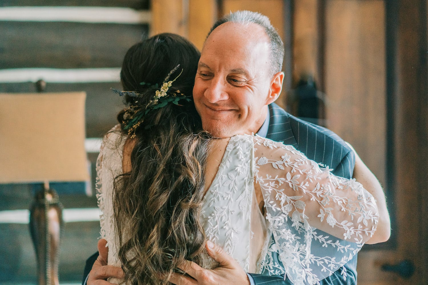 Bride hugs her dad during a first look at an elopement.