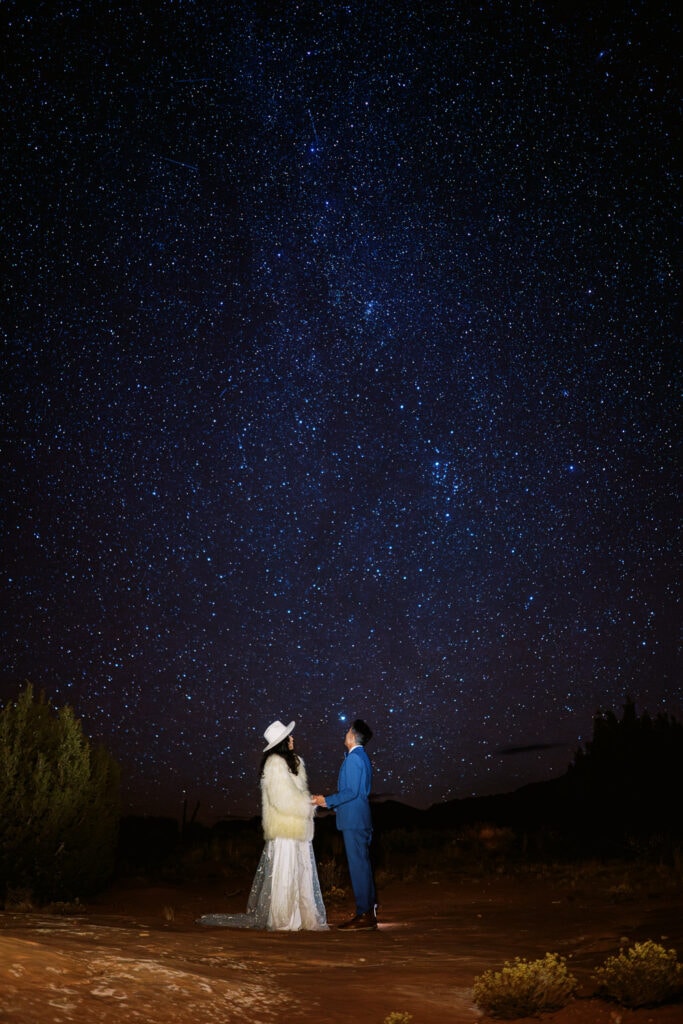 Bride and groom go stargazing after their wedding day in Moab.