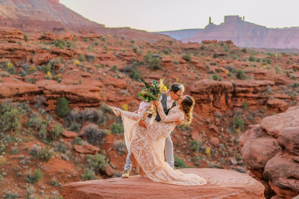 Bride and groom kiss during their adventure wedding in Moab, Utah.