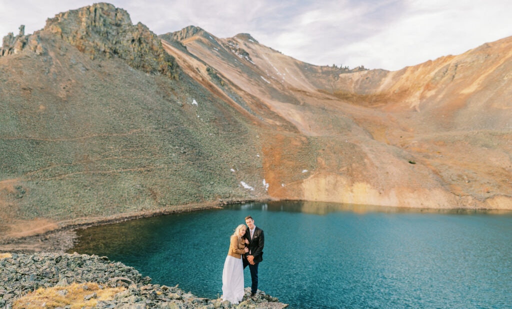 Bride and groom get married at an alpine lake in the mountains during their elopement in Colorado.