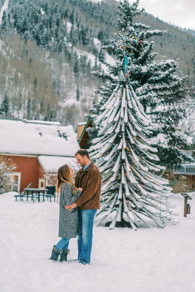 Engagement photography in Telluride, Colorado near the ski tree: a tree made up of old skis.