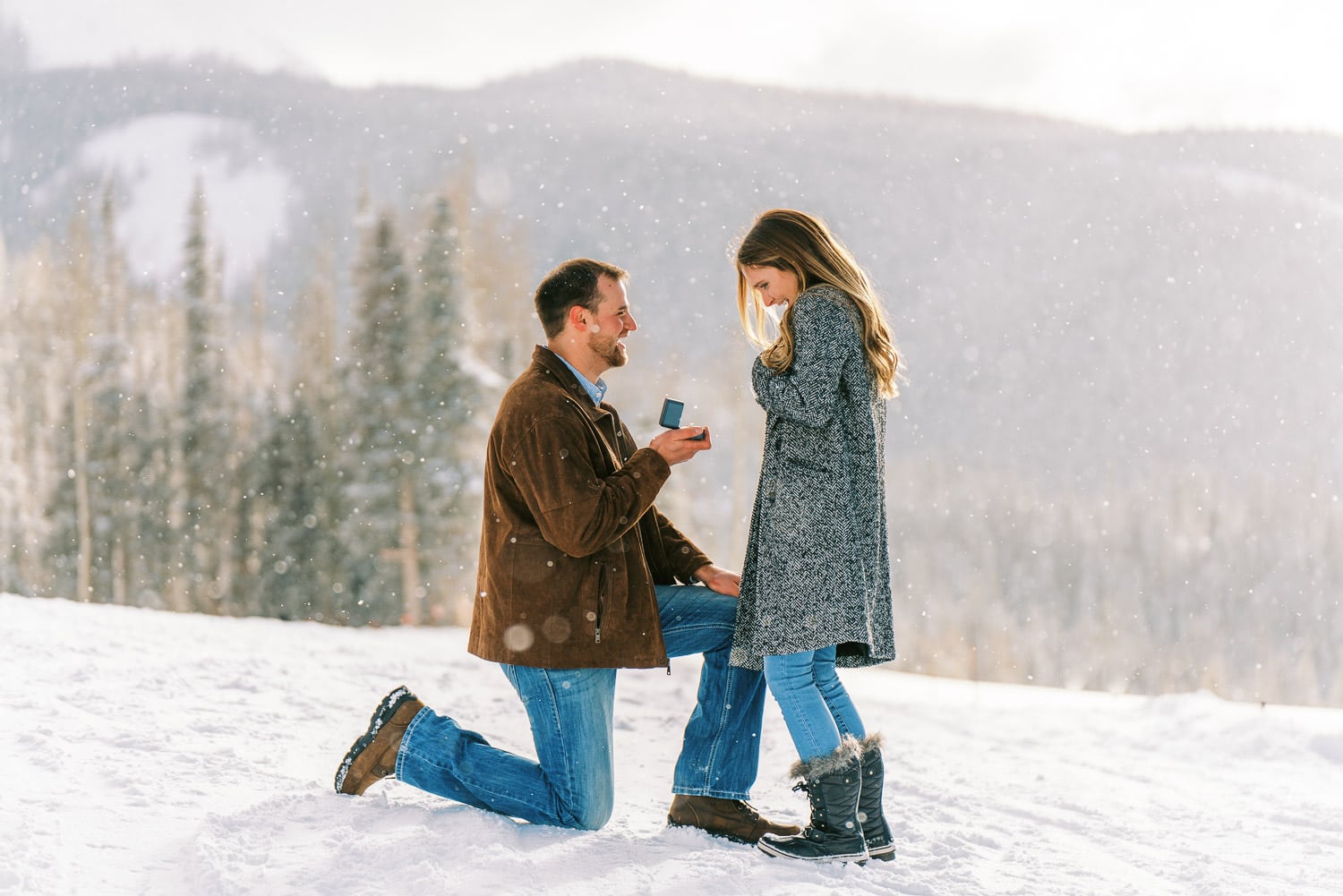 Photography of a Telluride, Colorado surprise proposal on a snowy mountain top.