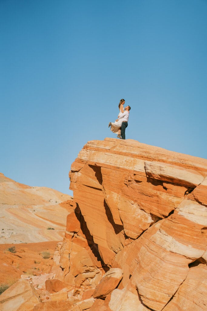 Bride and groom go hiking in Valley of Fire for elopement photography in Nevada.