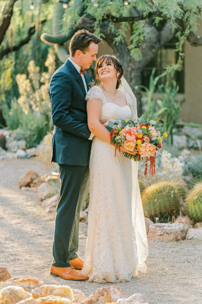 Bride and groom embrace for their Tucson Botanical Gardens wedding in the desert.