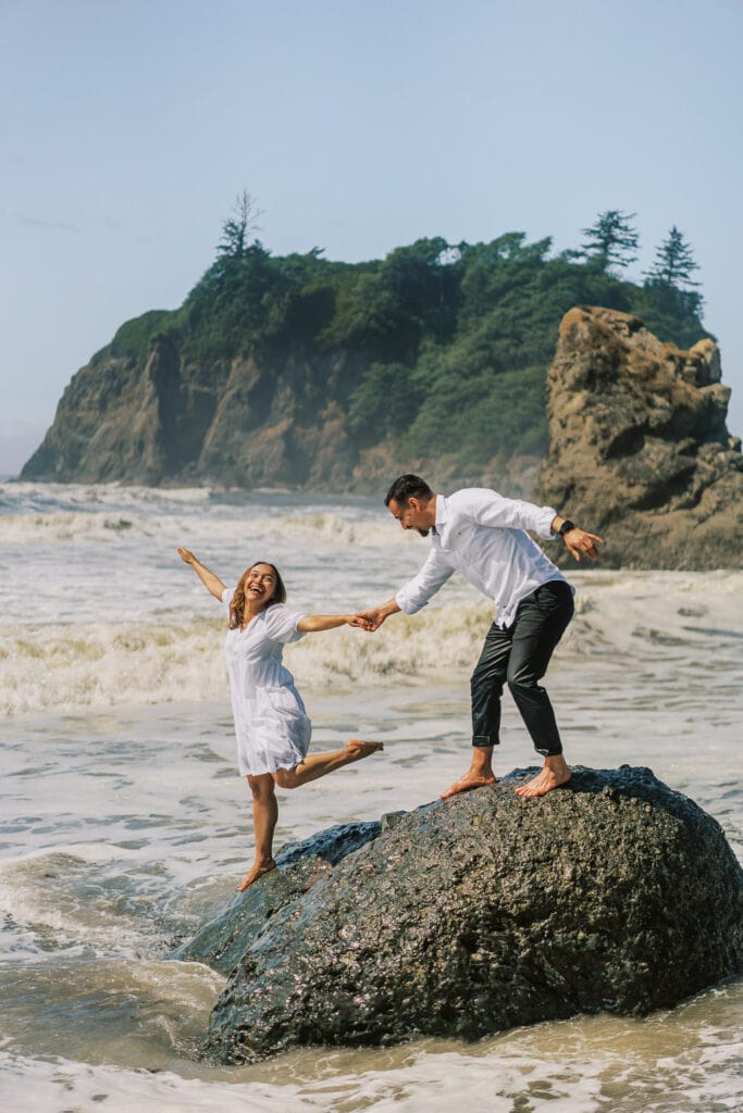 Bride and groom have fun during their elopement at Ruby Beach in Olympic National Park.