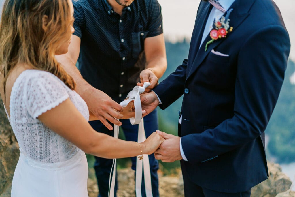 Bride and groom have a hand fasting ceremony for their elopement in Olympic National Park.