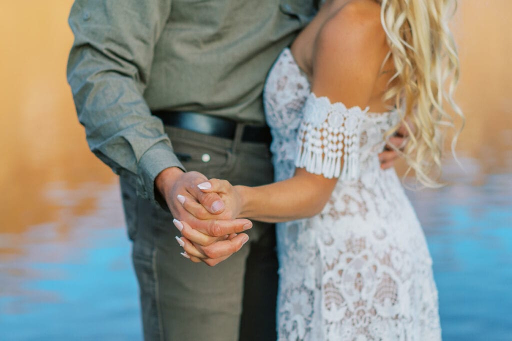 Bride and groom hold hands during their Colorado elopement.