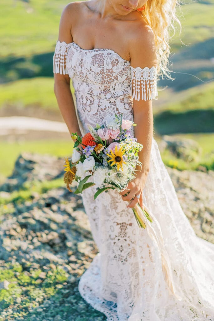 Bride holds a wildflower inspired bouquet for her elopement in Colorado.