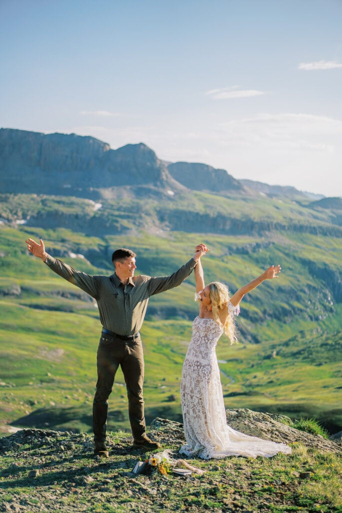 Bride and groom celebrate after getting married in the mountains of Colorado.