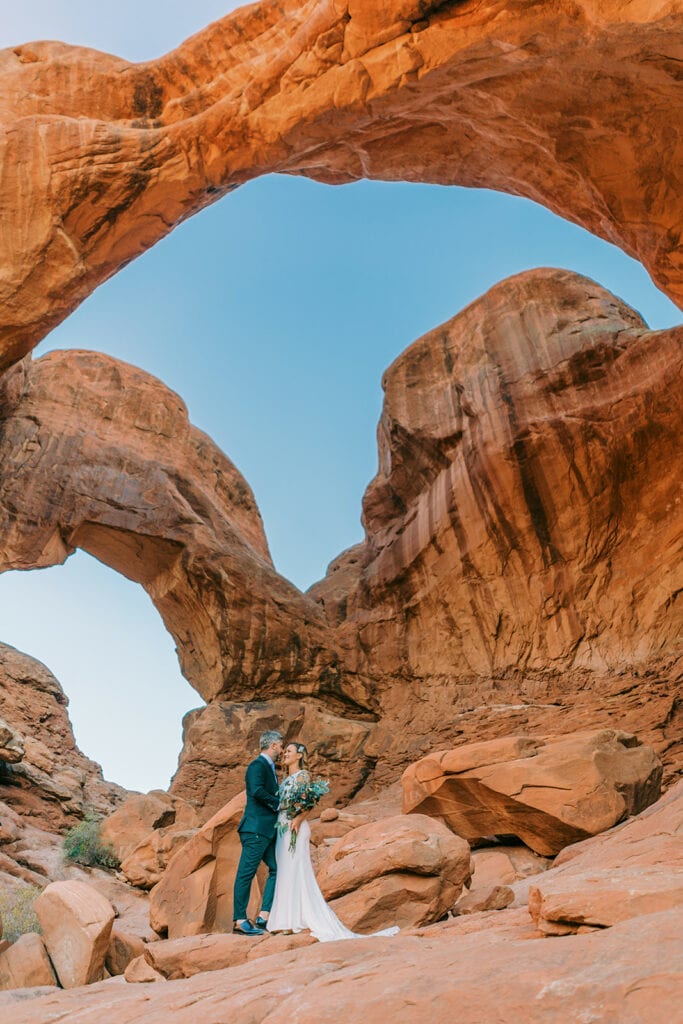 An elopement ceremony in Arches National Park at Double Arch in the Windows Section.