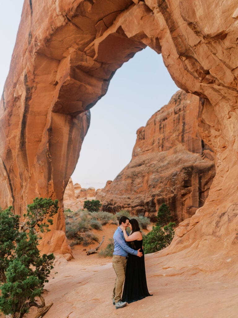 Couple's elopement ceremony at Pine Tree Arch in Arches National Park near Moab.