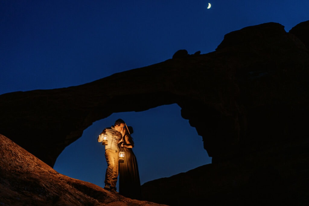 Couple has a lantern lit nighttime elopement at the Devil's Garden Campground Amphitheater in Arches National Park.