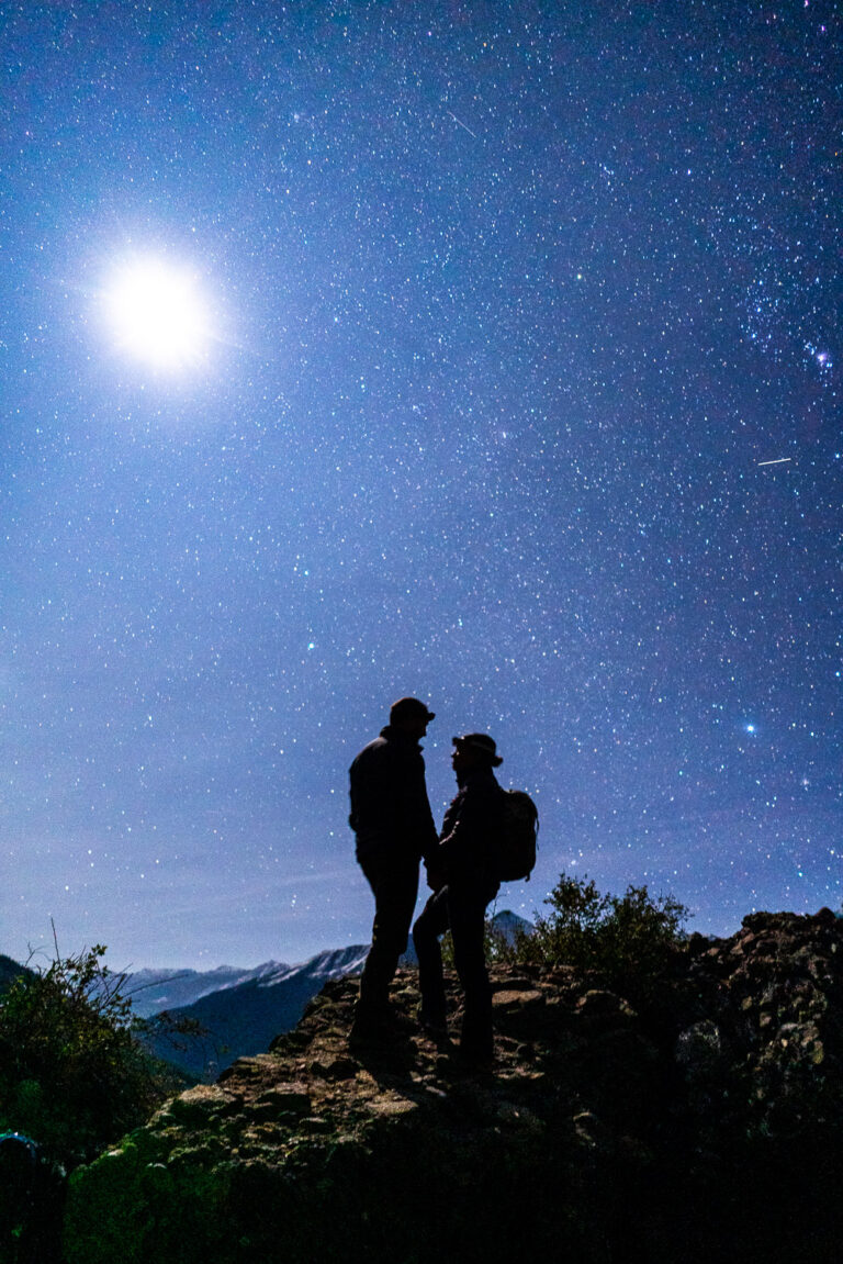 Couple hiking under the stars during their Silverton elopement in western Colorado.