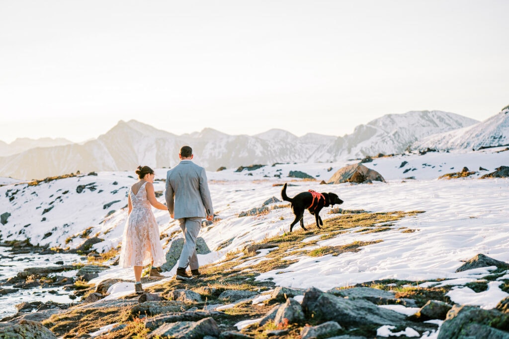 Bride and groom hiking together with their dog for their Silverton, Colorado elopement day.