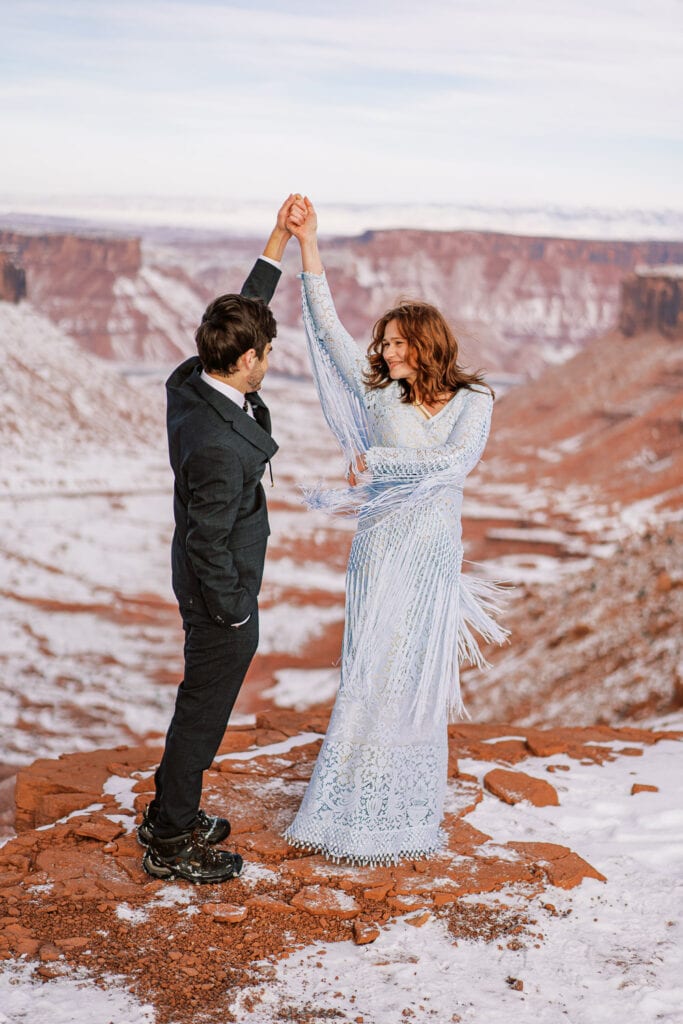 Couple has a first dance at their elopement in the desert.