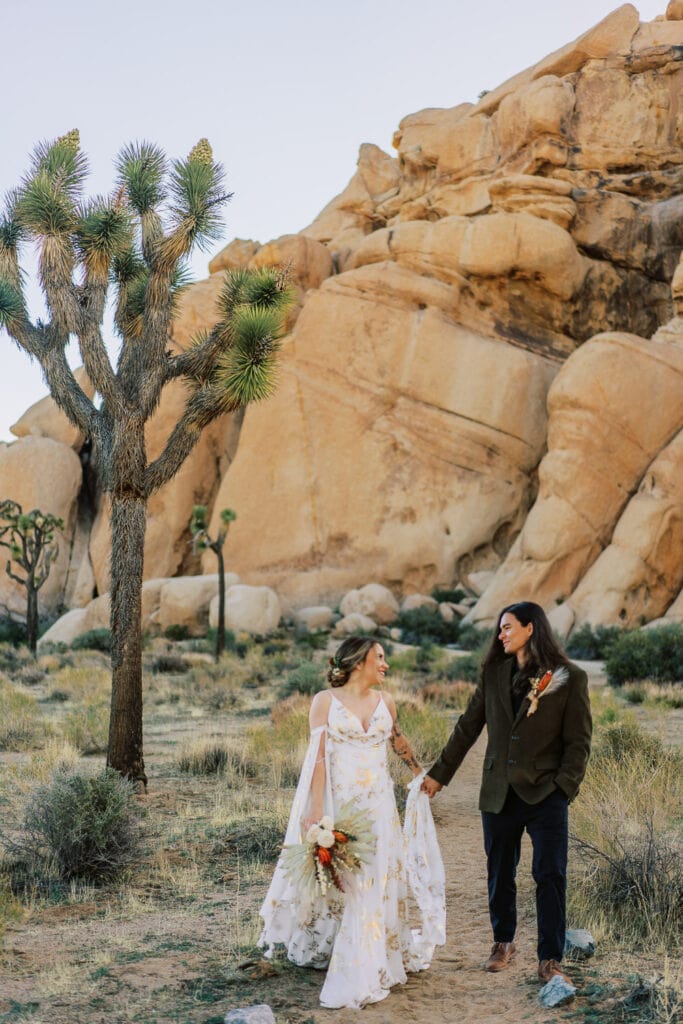 Bride and groom walk together during their elopement in Joshua Tree National Park.