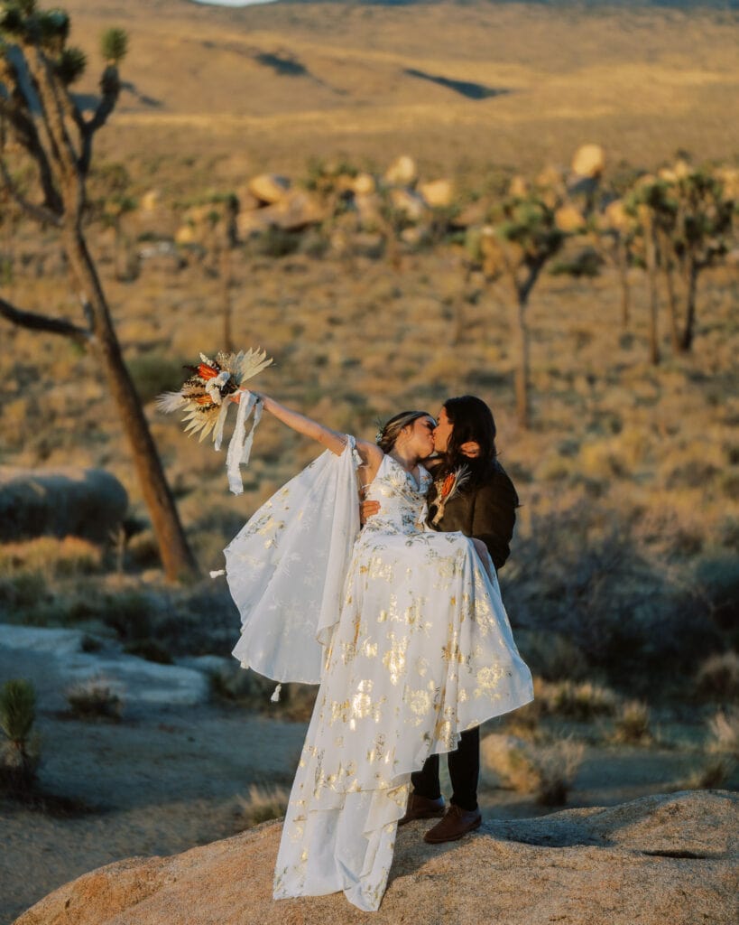 Bride and groom kissing during their Joshua Tree elopement celebration.