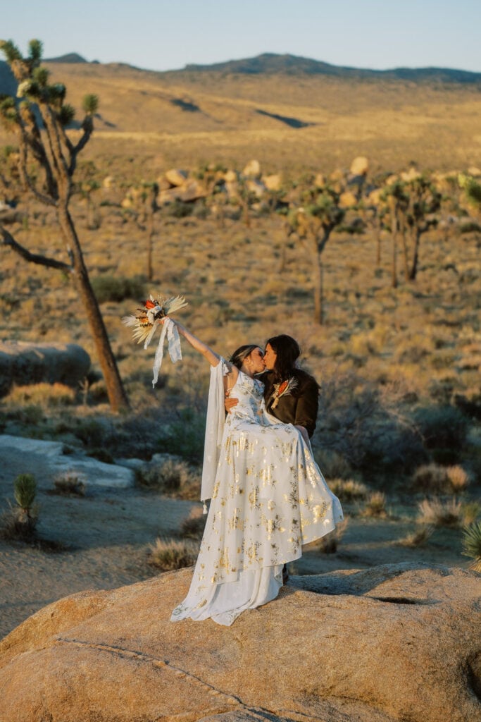 Bride and groom kiss during their elopement in Joshua Tree National Park.
