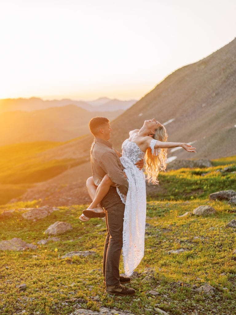 Colorado elopement photographer captures a bride and groom having fun on their wedding day at sunrise.
