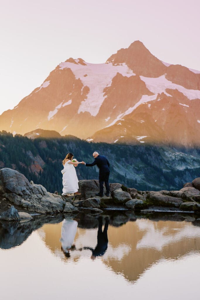 Bride and groom near a lake by Artist Point in Washington.