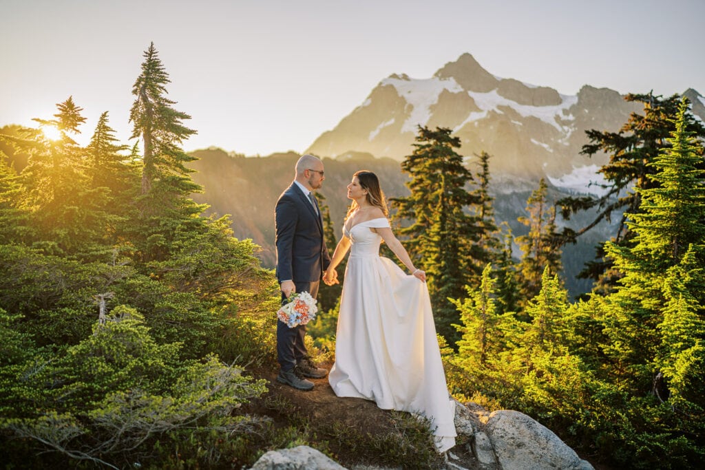 Bride and groom at sunrise near Artist Point with views of the Cascade Mountain range in the background.