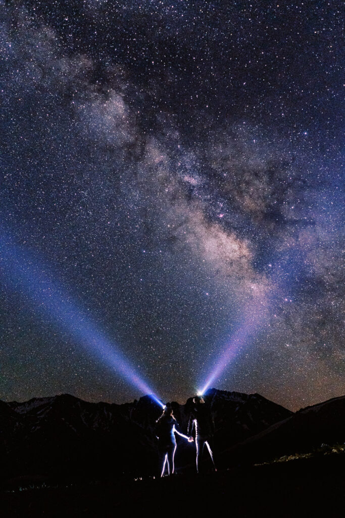 A couple goes stargazing in the mountains.
