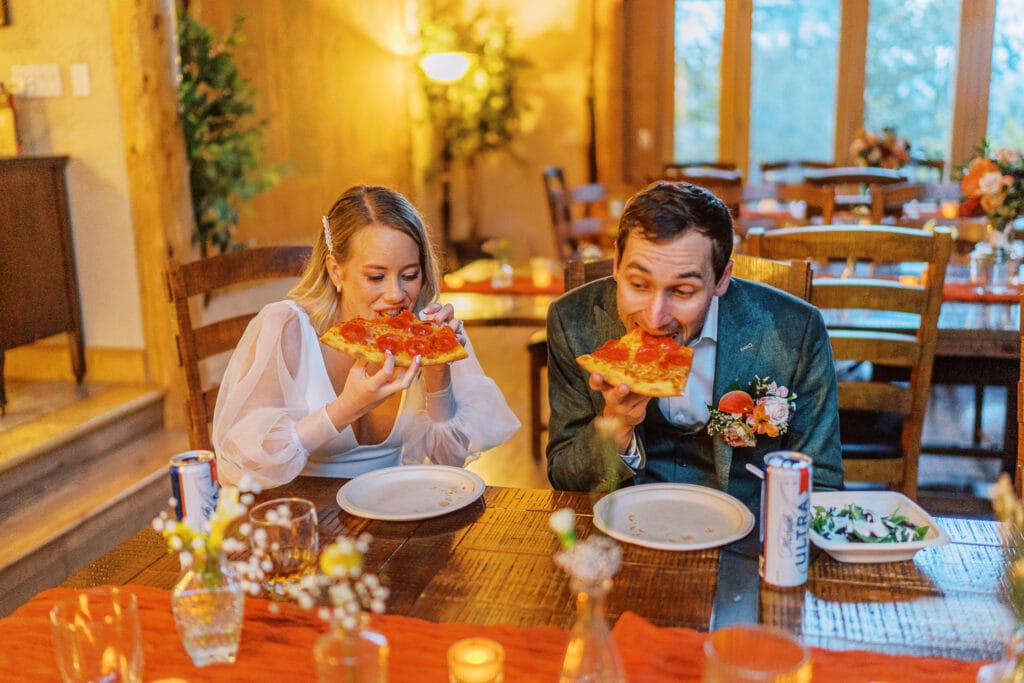 Couple eating pizza together at their post elopement party in Colorado.